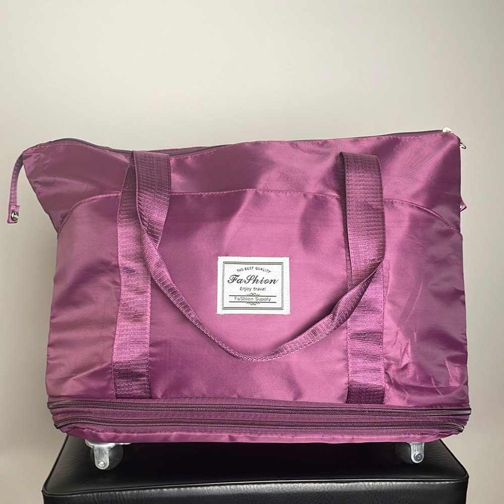 Expandable Travel bag with casters. New. Never used. Lightweight material.